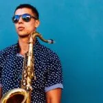 man holding saxophone instrument
