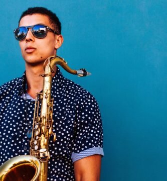 man holding saxophone instrument