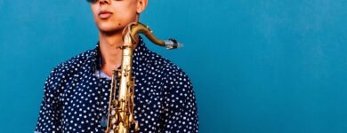 man holding saxophone instrument