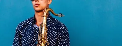 man holding saxophone instrument